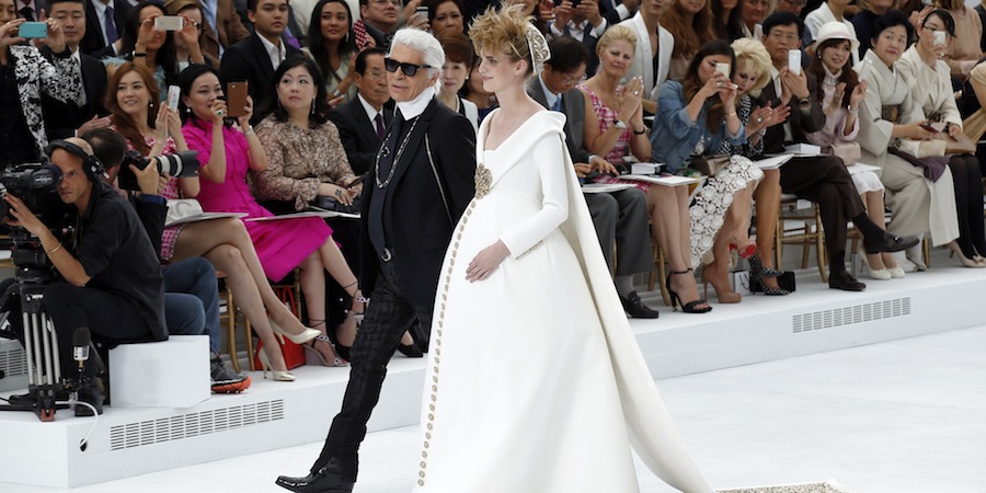 German designer Karl Lagerfeld and model Ashleigh Good appear at the end of his Haute Couture Fall/Winter 2014-2015 fashion show for French fashion house Chanel in Paris